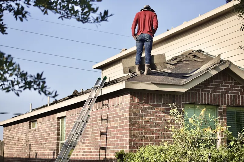 Professional roofer working on a residential roof in Katonah